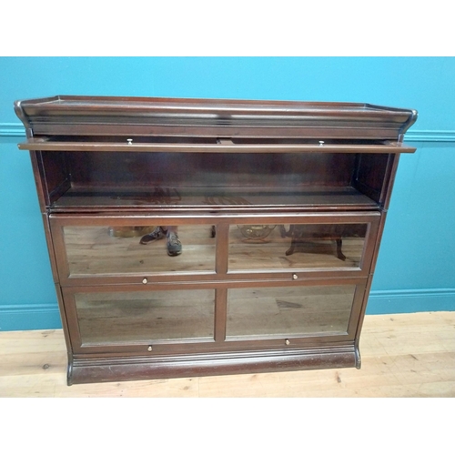 487 - 1940s mahogany stackable bookcase with folding glazed doors {113 cm H x 139 cm W x 36 cm D}.