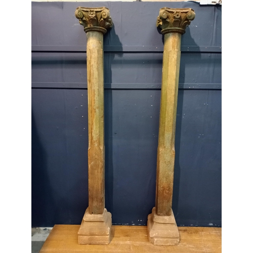 493A - Pair of wooden pillars with Corinthian wood top on sandstone base {H 220cm x W 30cm x D 30cm }.