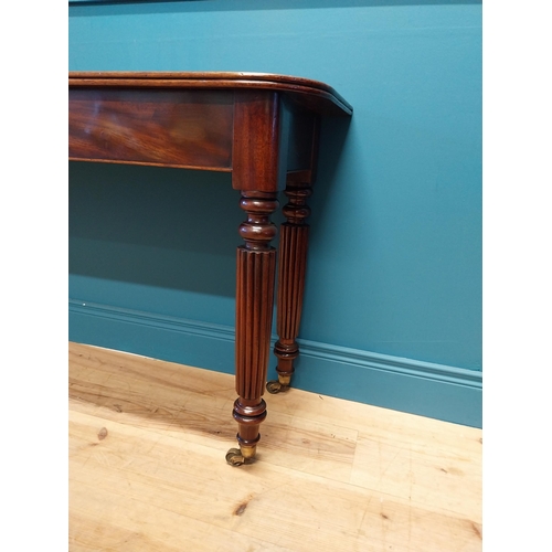 497 - Good quality William IV mahogany side table raised on reeded legs and brass castors {74 cm H x 138 c... 