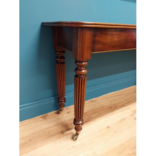 497 - Good quality William IV mahogany side table raised on reeded legs and brass castors {74 cm H x 138 c... 