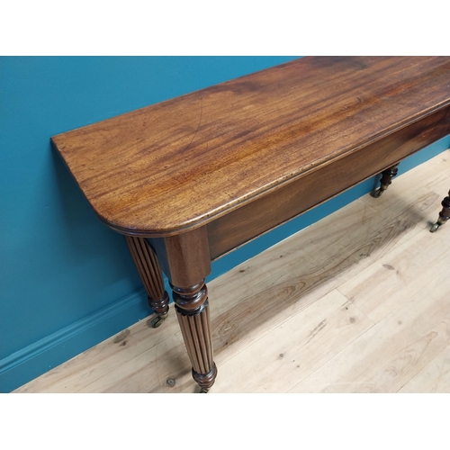 497 - Good quality William IV mahogany side table raised on reeded legs and brass castors {74 cm H x 138 c... 