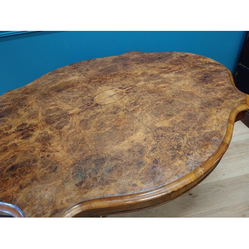 517 - Good quality Victorian burr walnut tilt top centre table raised on turned column and four outswept f... 