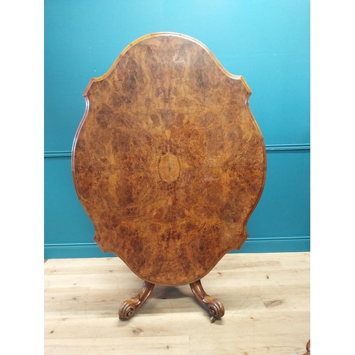 517 - Good quality Victorian burr walnut tilt top centre table raised on turned column and four outswept f... 