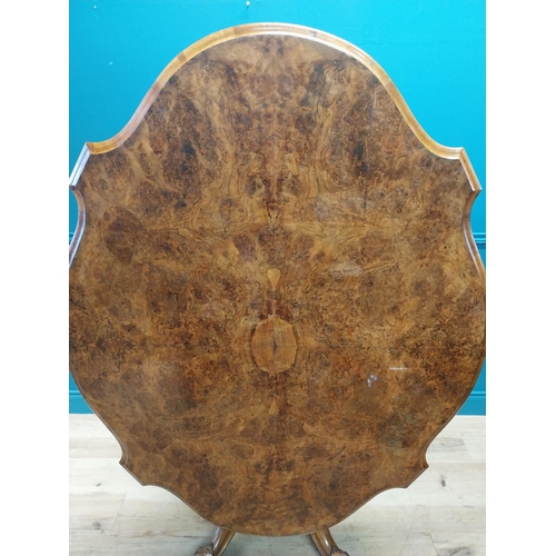 517 - Good quality Victorian burr walnut tilt top centre table raised on turned column and four outswept f... 