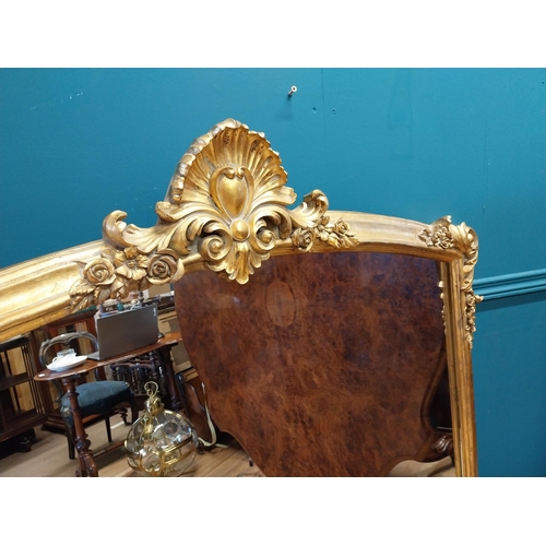 527 - Decorative gilt overmantle mirror in the Rocco style {137 cm H x 130 cm W}.