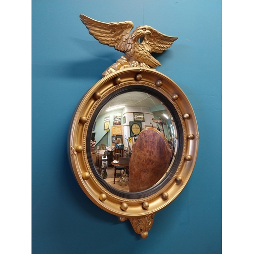 537 - Good quality giltwood convex mirror surmounted by Eagle in the Regency style {70 cm H x 47 cm W}.