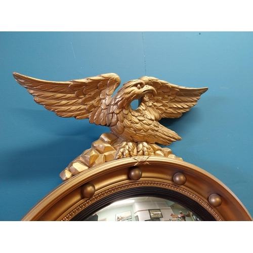 537 - Good quality giltwood convex mirror surmounted by Eagle in the Regency style {70 cm H x 47 cm W}.