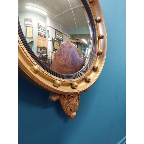 537 - Good quality giltwood convex mirror surmounted by Eagle in the Regency style {70 cm H x 47 cm W}.