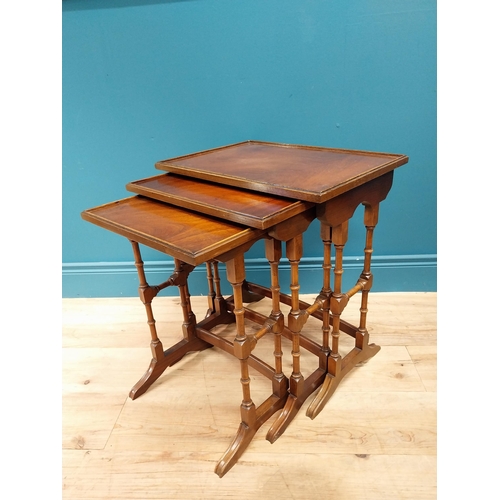 557 - Good quality Edwardian mahogany nest of three table raised on turned columns and platform feet {56 c... 