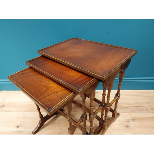 557 - Good quality Edwardian mahogany nest of three table raised on turned columns and platform feet {56 c... 