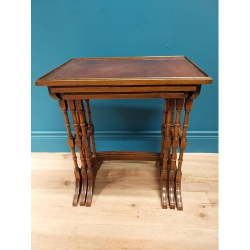 557 - Good quality Edwardian mahogany nest of three table raised on turned columns and platform feet {56 c... 