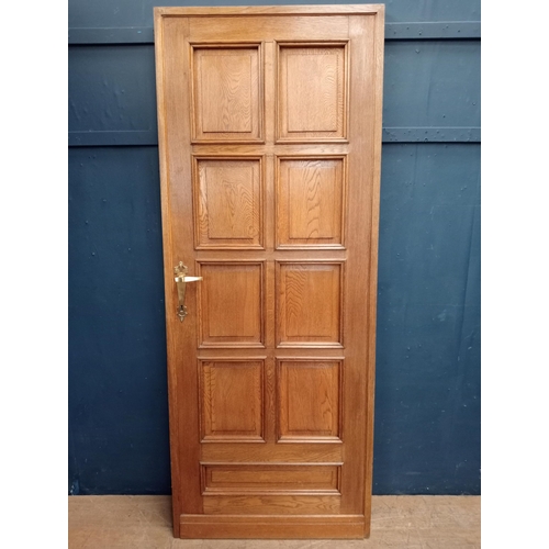 563 - 1900's Solid oak double sided eight panel door with brass door handles {H 201cm x W 80cm x D 5cm }.