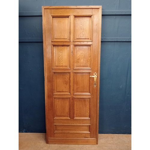 563 - 1900's Solid oak double sided eight panel door with brass door handles {H 201cm x W 80cm x D 5cm }.