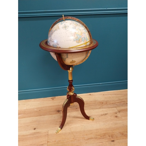 567 - Good quality mahogany and gilded brass world globe raised on turned column and three outswept feet {... 