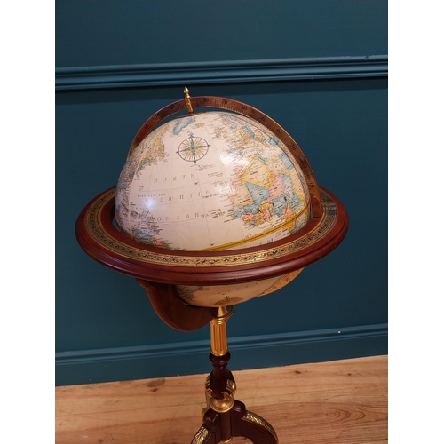 567 - Good quality mahogany and gilded brass world globe raised on turned column and three outswept feet {... 