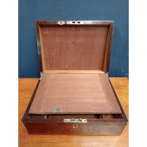 597 - Victorian brass bound rosewood writing slope. {H 11cm x W 30cm x D 22cm }.