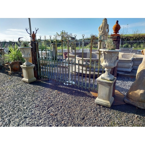 600 - Pair of moulded stone Grecian urns on square bases. {110 cm H x 39 cm W x 39 cm D}.