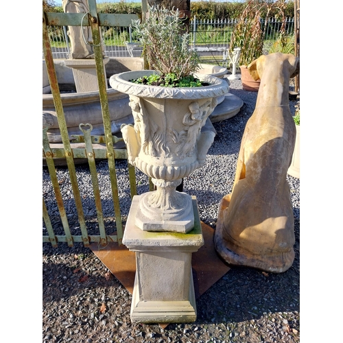 600 - Pair of moulded stone Grecian urns on square bases. {110 cm H x 39 cm W x 39 cm D}.