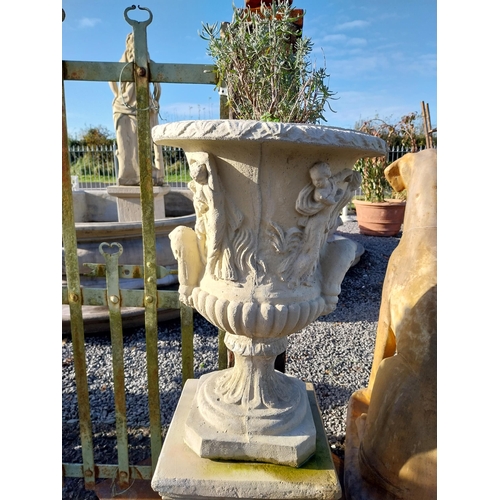 600 - Pair of moulded stone Grecian urns on square bases. {110 cm H x 39 cm W x 39 cm D}.