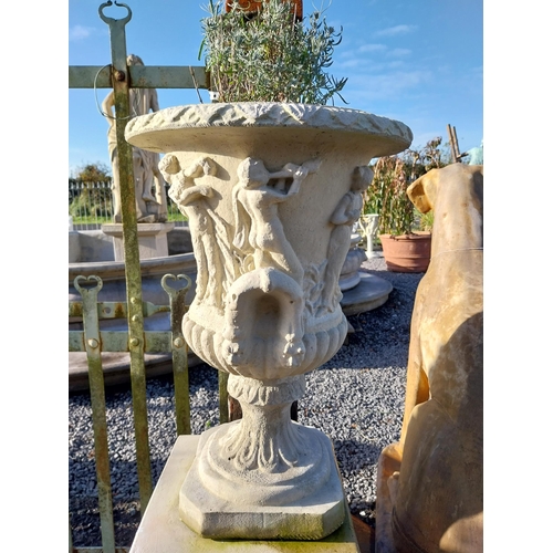 600 - Pair of moulded stone Grecian urns on square bases. {110 cm H x 39 cm W x 39 cm D}.