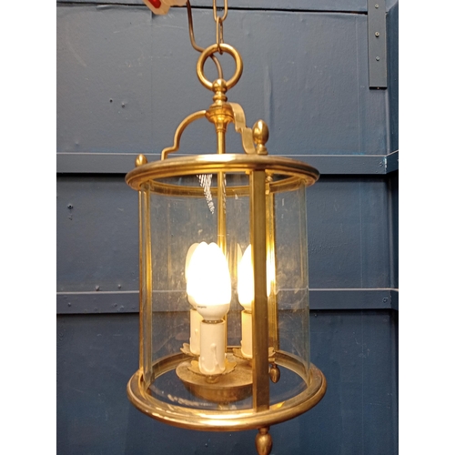 61 - Decorative brass and glass hanging hall lantern. {H 34cm x Dia 16cm }.