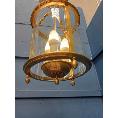 61 - Decorative brass and glass hanging hall lantern. {H 34cm x Dia 16cm }.