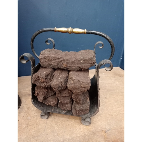 652 - Wrought iron and brass log holder {H 38cm x W 39cm x D 29cm }.