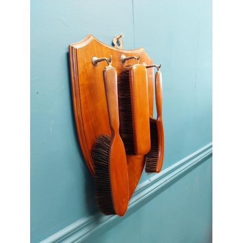 697 - 1940s mahogany wall hanging clothes brush set {46 cm H x 27 cm W}.