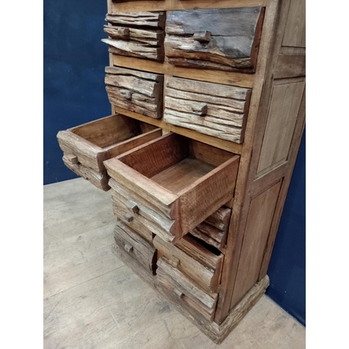 665 - Fourteen drawer driftwood chest {H 146cm x W 75cm x D 42cm}.