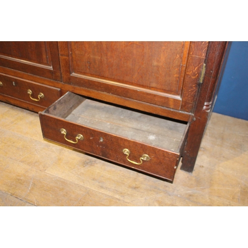 671 - 19th C. Oak linen press with two long doors over two short drawers with brass handles on square legs... 