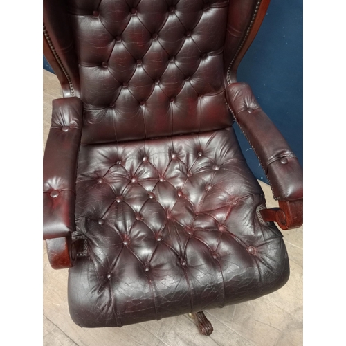 683 - Red leather deep button swivel office chair {H 113cm x W 63cm x D 65cm}.