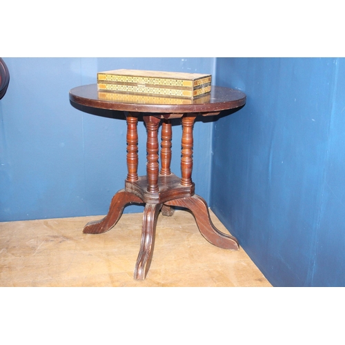 688 - Bar table with four turned supports on four outswept feet. {H 67cm x D 70cm}.