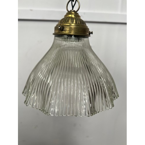 714 - Brass pendant light with holophane ribbed glass shade {Dia 19cm X H67cm}.