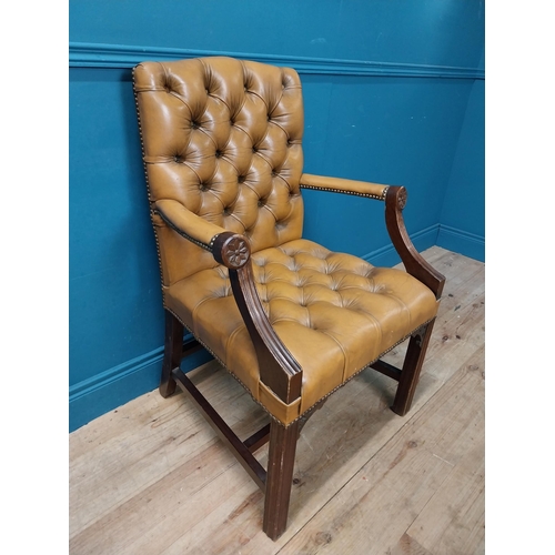 102 - Mahogany deep buttoned leather upholstered Gainsborough armchair with upholstered arms terminating i... 