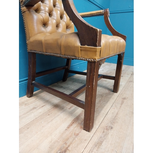 102 - Mahogany deep buttoned leather upholstered Gainsborough armchair with upholstered arms terminating i... 