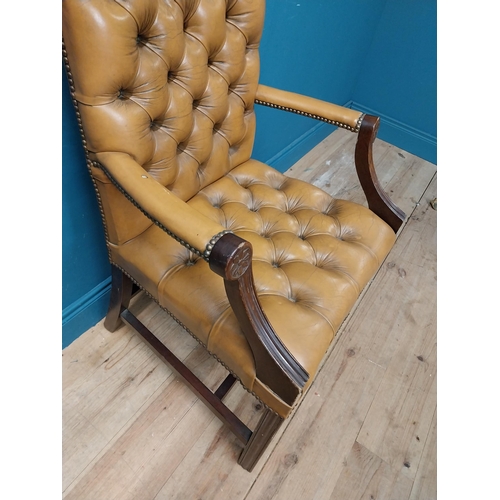 102 - Mahogany deep buttoned leather upholstered Gainsborough armchair with upholstered arms terminating i... 