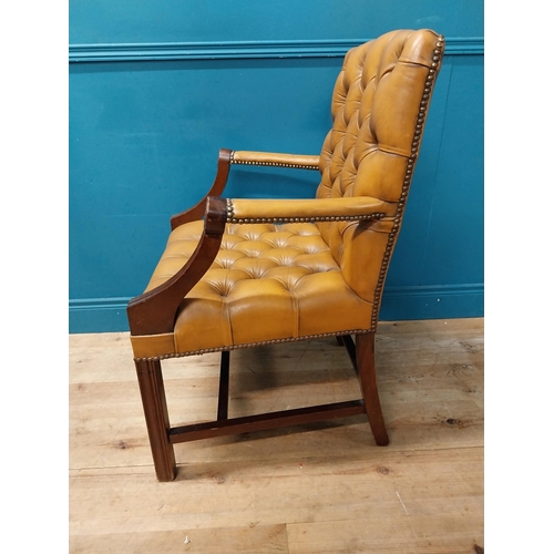 102 - Mahogany deep buttoned leather upholstered Gainsborough armchair with upholstered arms terminating i... 