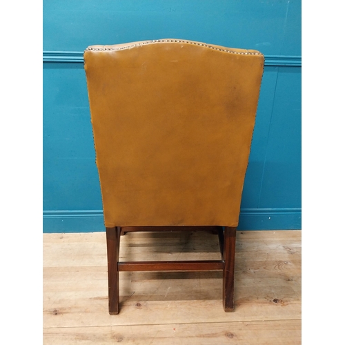 102 - Mahogany deep buttoned leather upholstered Gainsborough armchair with upholstered arms terminating i... 