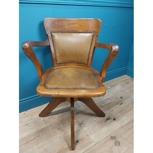 106 - Early 20th C. oak and leather upholstered office chair. {86 cm H x 60 cm W x 53 cm D}.