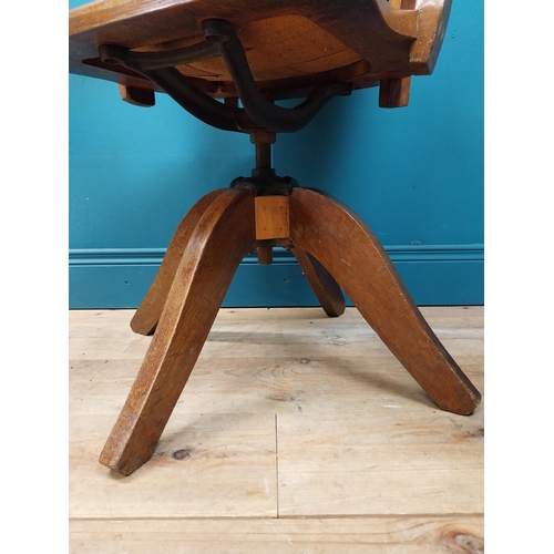 106 - Early 20th C. oak and leather upholstered office chair. {86 cm H x 60 cm W x 53 cm D}.