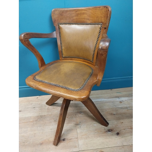 106 - Early 20th C. oak and leather upholstered office chair. {86 cm H x 60 cm W x 53 cm D}.