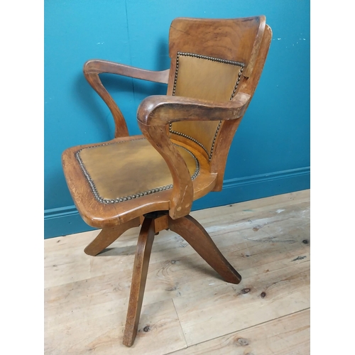 106 - Early 20th C. oak and leather upholstered office chair. {86 cm H x 60 cm W x 53 cm D}.