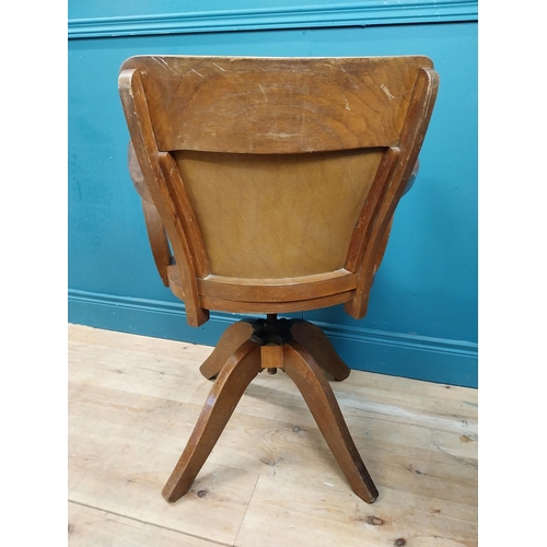 106 - Early 20th C. oak and leather upholstered office chair. {86 cm H x 60 cm W x 53 cm D}.