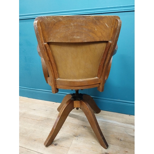 106 - Early 20th C. oak and leather upholstered office chair. {86 cm H x 60 cm W x 53 cm D}.