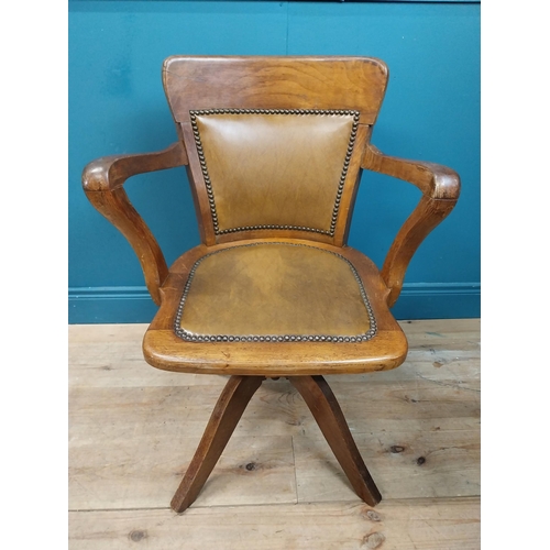 106 - Early 20th C. oak and leather upholstered office chair. {86 cm H x 60 cm W x 53 cm D}.