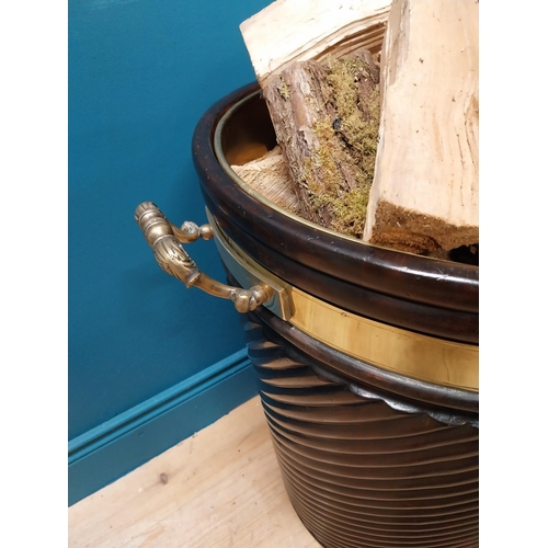 109 - Irish mahogany spiral brass bound peat bucket in the Georgian style {66cm H x 62cm Dia}