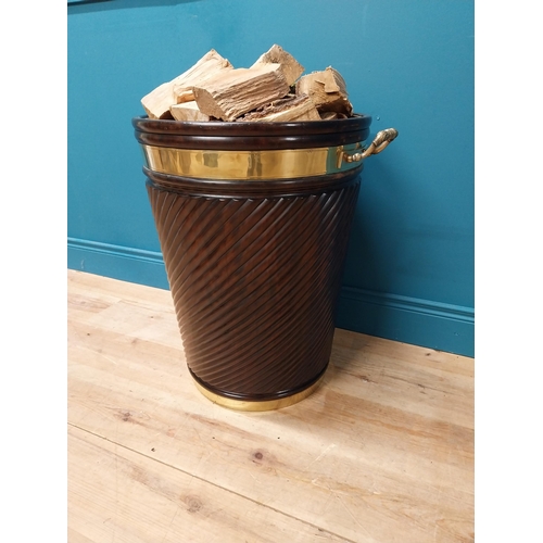 109 - Irish mahogany spiral brass bound peat bucket in the Georgian style {66cm H x 62cm Dia}