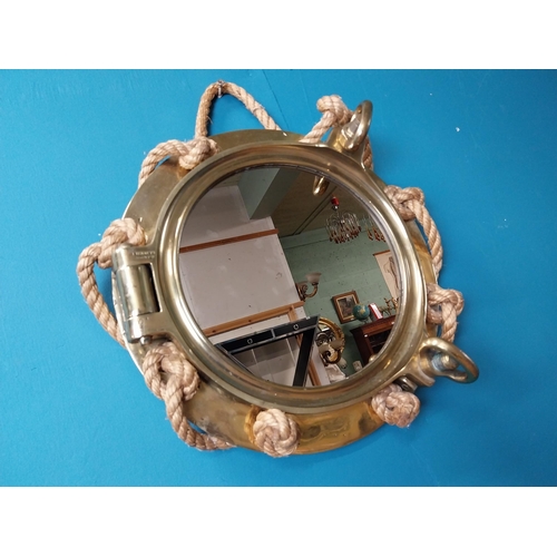 123 - Brass ship's porthole in the form of mirror with rope decoration stamped J J Woods Rainhill. {40 cm ... 