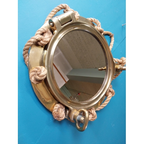 123 - Brass ship's porthole in the form of mirror with rope decoration stamped J J Woods Rainhill. {40 cm ... 