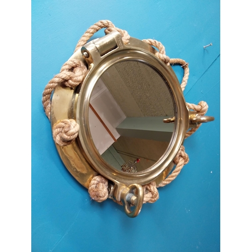 123 - Brass ship's porthole in the form of mirror with rope decoration stamped J J Woods Rainhill. {40 cm ... 